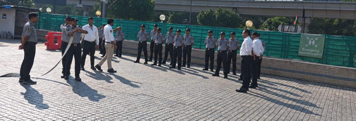Elite Security Service guards taking part in a fire-safety drill with a hose