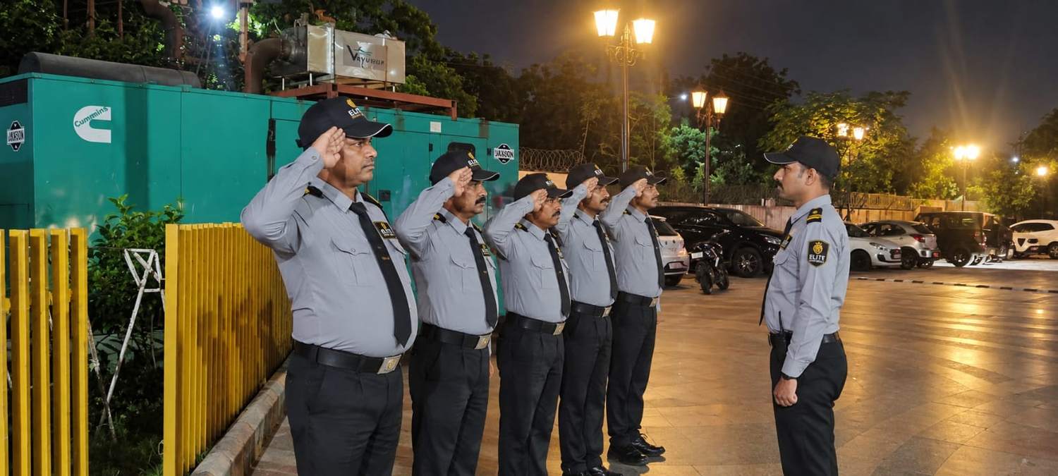 Elite Security Service guards saluting their supervisor at a night parade